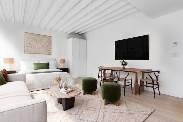 bedroom with light wood-style flooring, baseboards, and beam ceiling