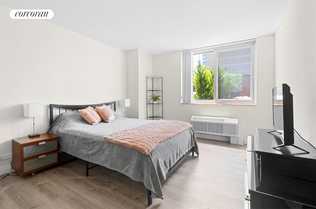 bedroom featuring light wood-style floors and visible vents