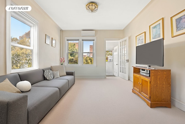 living room with light carpet, baseboards, and a wall mounted AC