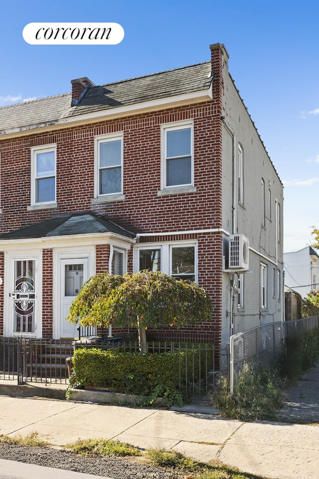 view of front of house with a fenced front yard and brick siding