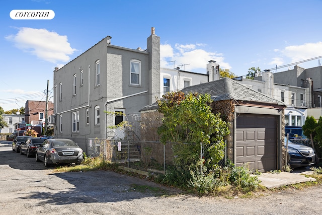 view of front facade with a garage and fence