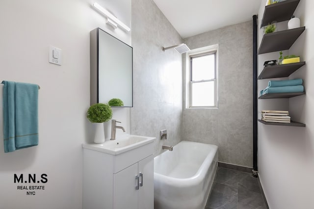 bathroom featuring bathing tub / shower combination, vanity, and baseboards