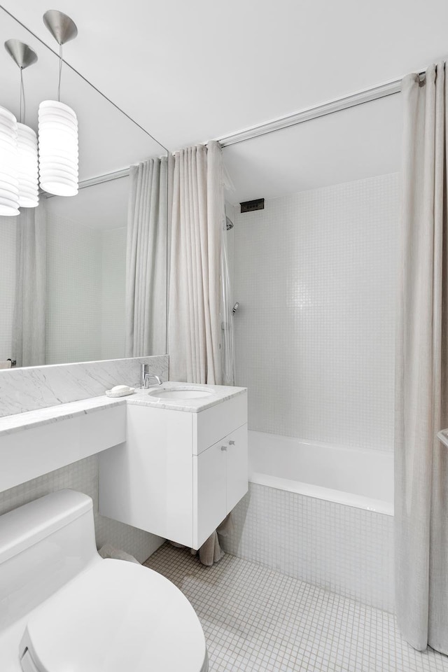 full bath featuring shower / bath combination with curtain, tile patterned flooring, vanity, and toilet