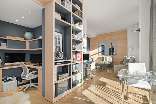 office area featuring wood walls, recessed lighting, wood finished floors, and built in study area