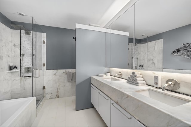 bathroom featuring double vanity, a stall shower, a sink, and a washtub