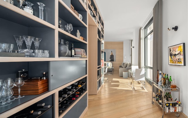 wine cellar with beverage cooler and wood finished floors