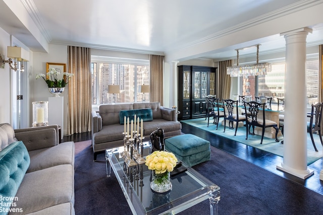 living area with wood finished floors, ornate columns, and ornamental molding