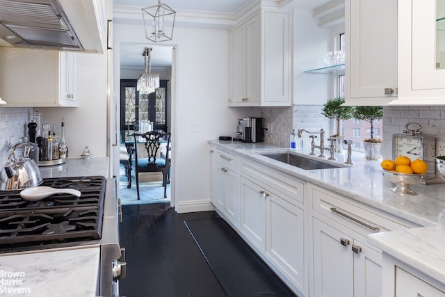 kitchen featuring a sink, range, white cabinetry, backsplash, and under cabinet range hood