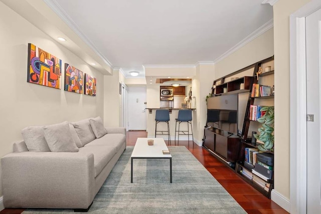 living room with dark wood-type flooring, crown molding, and baseboards