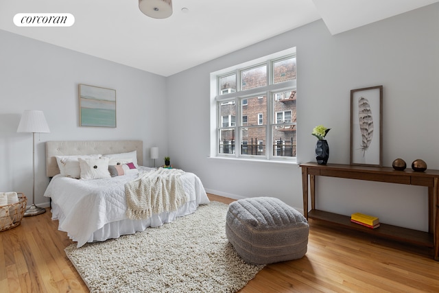bedroom featuring baseboards and wood finished floors