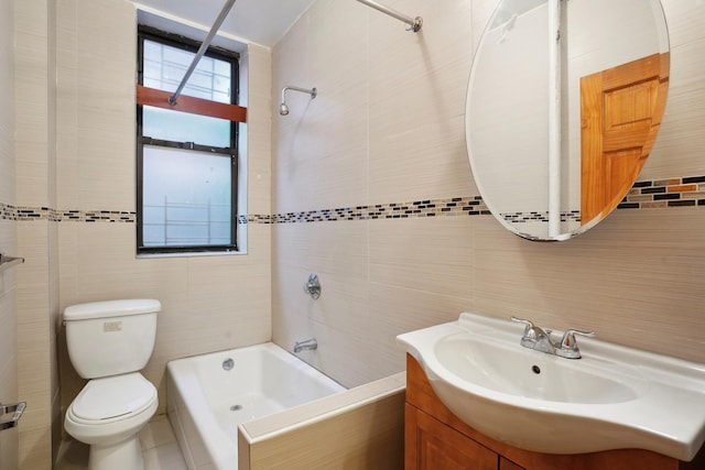 bathroom with shower / tub combination, toilet, tile walls, and vanity