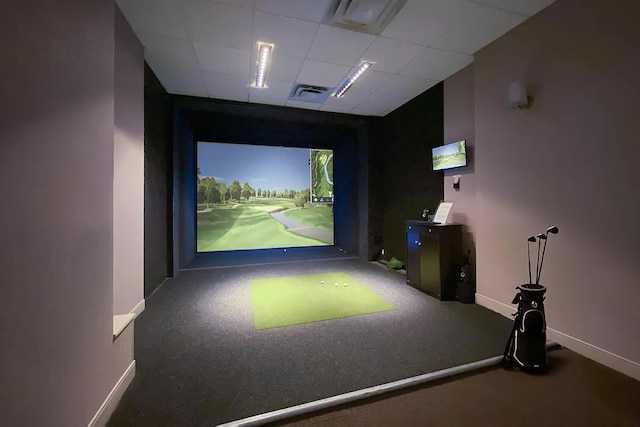 game room featuring baseboards, golf simulator, a drop ceiling, and visible vents