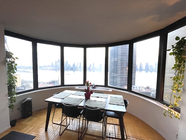 dining room featuring a view of city and a water view
