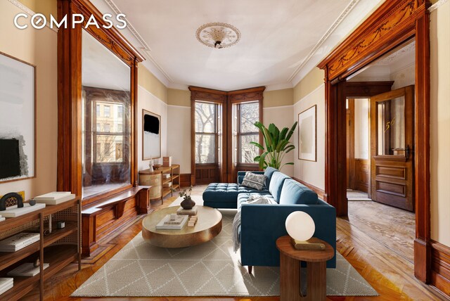 living room with wood finished floors and ornamental molding