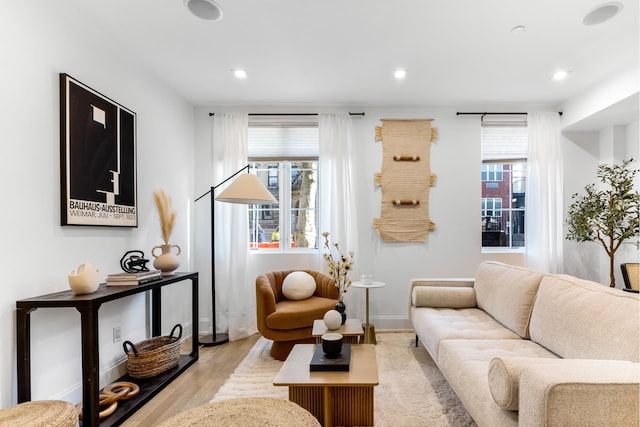 living room with plenty of natural light, wood finished floors, and recessed lighting