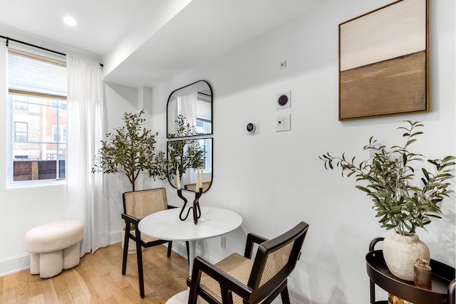 dining area with baseboards and light wood-style floors