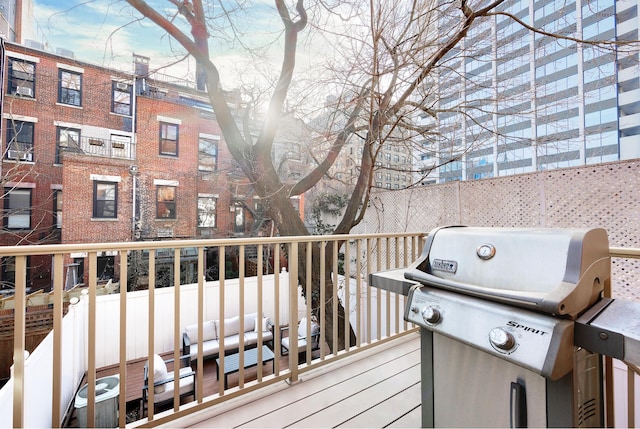 wooden deck with central AC and area for grilling