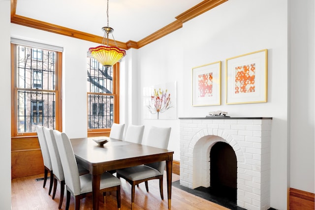 dining area with ornamental molding and wood finished floors