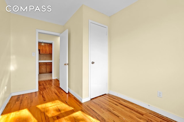 interior space featuring light wood-style floors and baseboards