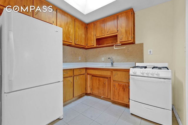 kitchen with a sink, white appliances, light countertops, light tile patterned floors, and backsplash
