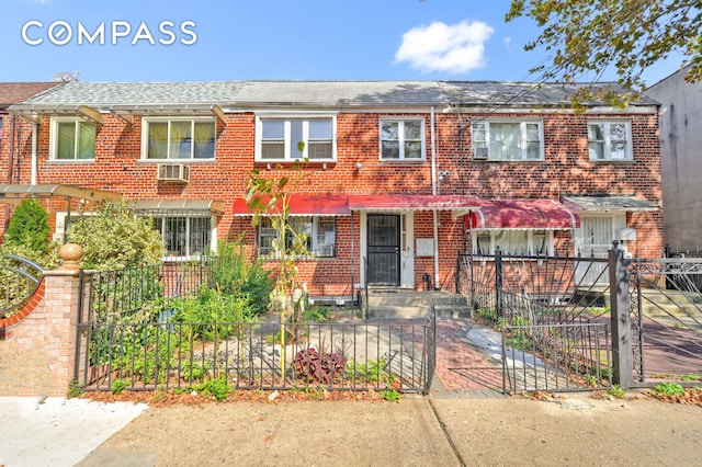 view of property featuring a fenced front yard and brick siding