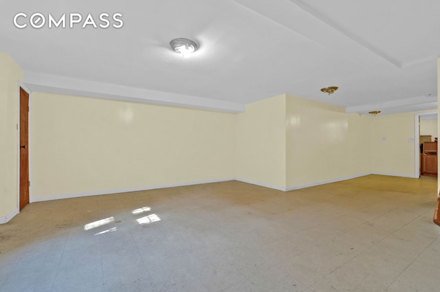 finished below grade area with baseboards and light floors