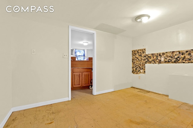 empty room with light floors and baseboards