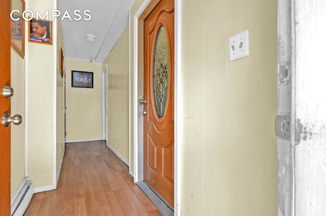 property entrance with a baseboard radiator and a porch