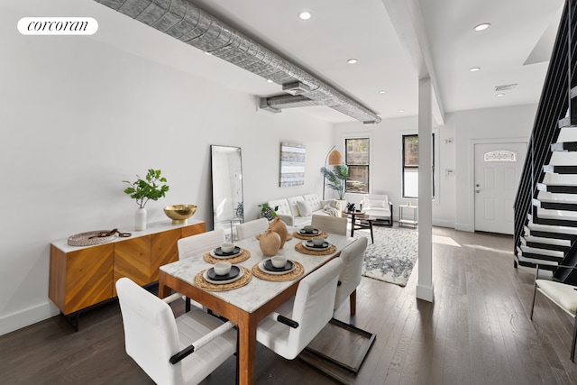 dining room with stairs, dark wood-type flooring, visible vents, and baseboards