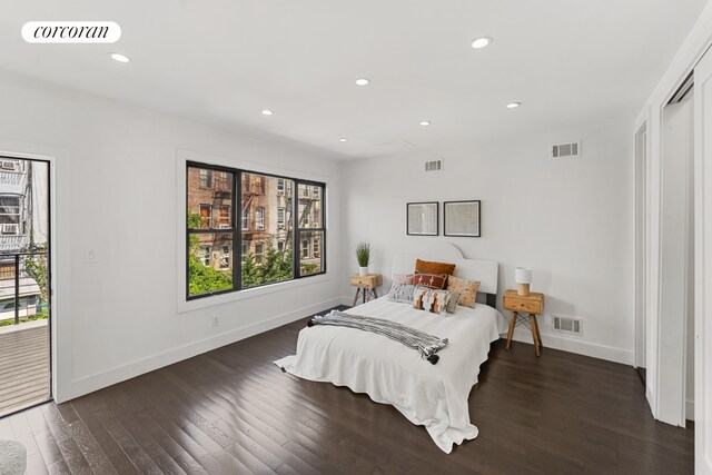 bedroom with access to outside, visible vents, and hardwood / wood-style floors