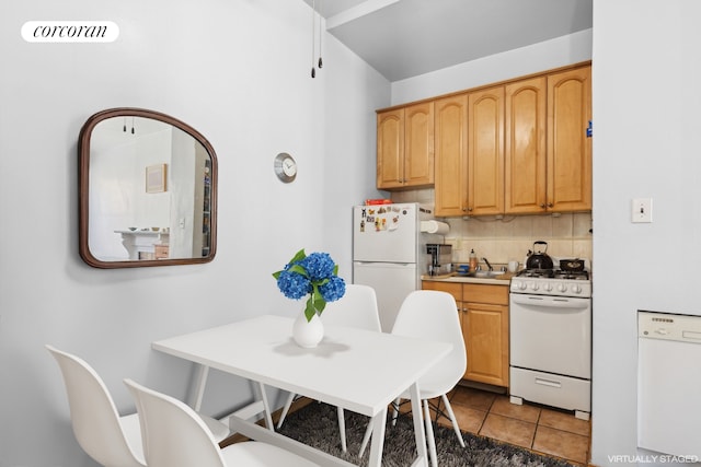 kitchen featuring light tile patterned floors, white appliances, visible vents, light countertops, and backsplash