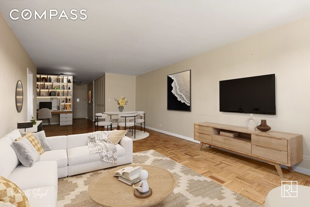 living area featuring baseboards