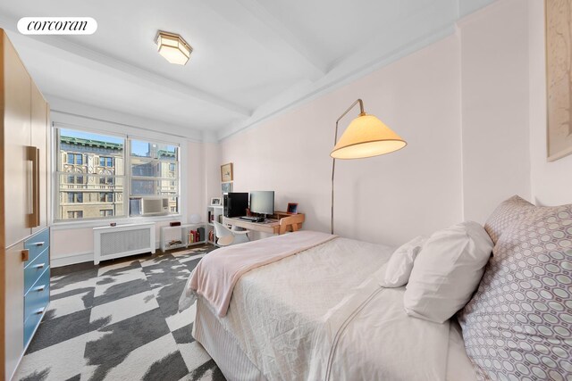 bedroom with radiator, visible vents, and beam ceiling