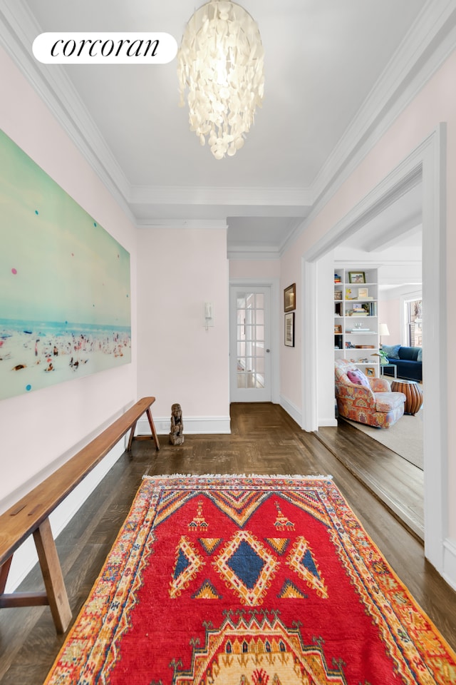 interior space featuring a chandelier, crown molding, baseboards, and parquet flooring