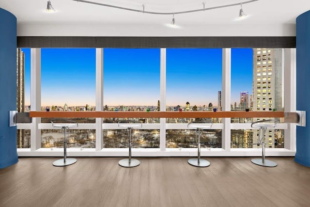 unfurnished sunroom featuring a city view and plenty of natural light