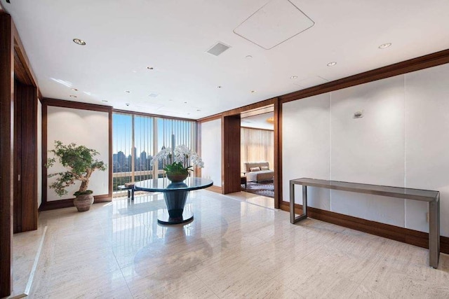 building lobby with floor to ceiling windows and crown molding
