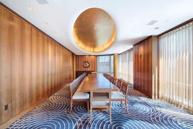 dining space with wood walls