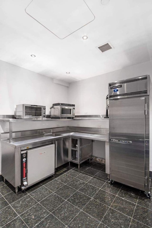 kitchen featuring stainless steel fridge, visible vents, fridge, granite finish floor, and recessed lighting