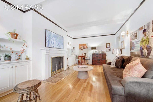 living room featuring a tiled fireplace and light wood-style floors