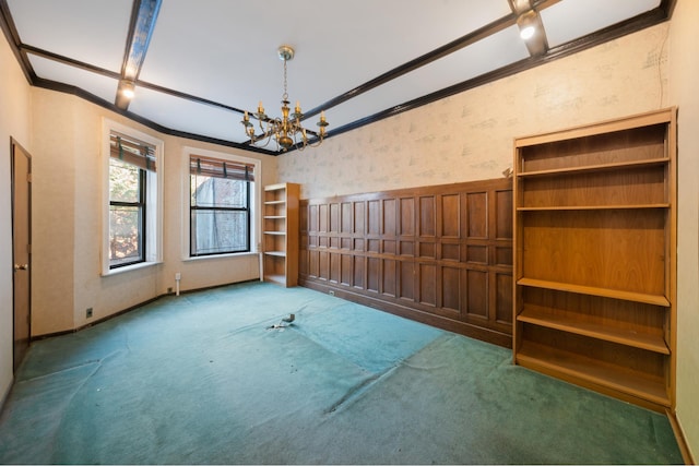 spare room featuring ornamental molding, carpet, a chandelier, and wallpapered walls