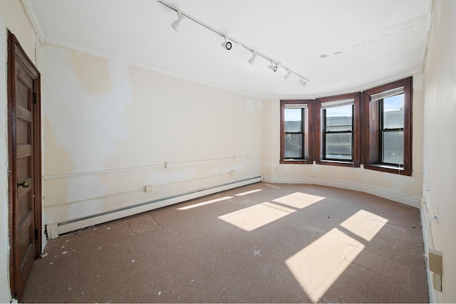 unfurnished room featuring a baseboard heating unit and baseboards