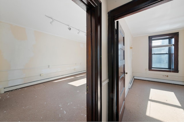 hall featuring a baseboard heating unit and track lighting