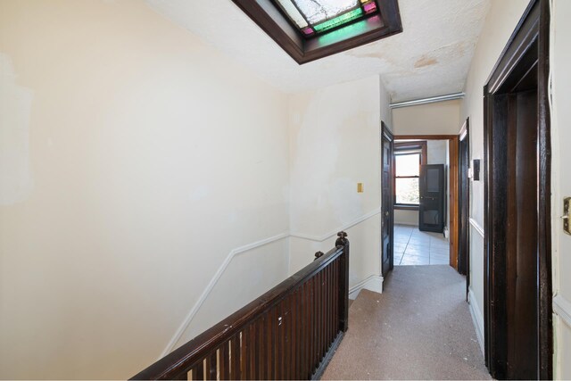 hall featuring a skylight and a textured ceiling