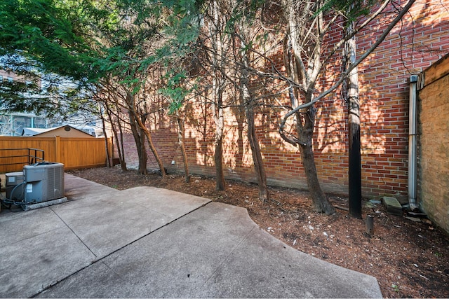 view of patio / terrace with central AC and fence