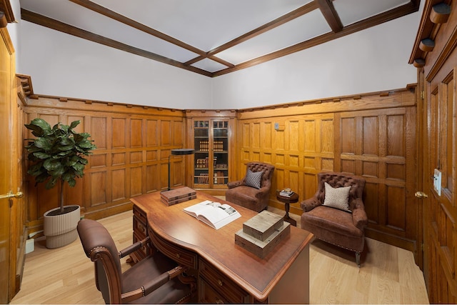 office area with light wood-type flooring and a decorative wall