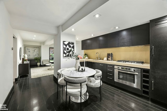 254 Park Ave S Garden, Unit Garden, New York City, NY 10010 - kitchen featuring dark cabinets, light countertops, stainless steel appliances, and dark wood finished floors