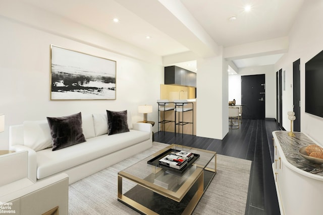 living area featuring beamed ceiling, dark wood-type flooring, and recessed lighting