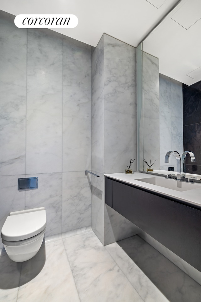 520 W 28th St Unit 29, New York City, NY 10001 - bathroom with vanity, tile walls, and marble finish floors