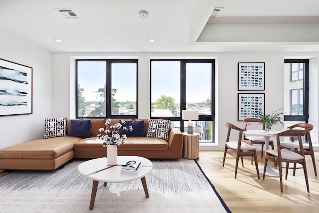 living area featuring light wood-style flooring, visible vents, and recessed lighting