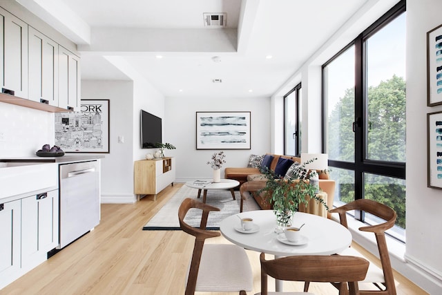 interior space featuring a wealth of natural light, visible vents, light wood finished floors, and recessed lighting